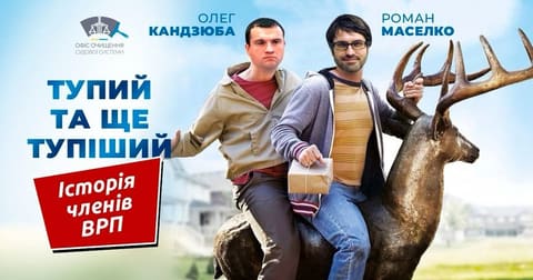 Афіша «Тупий та ще тупіший» із портретами Олега Кандзюби та Романа Маселка на скульптурі оленя.